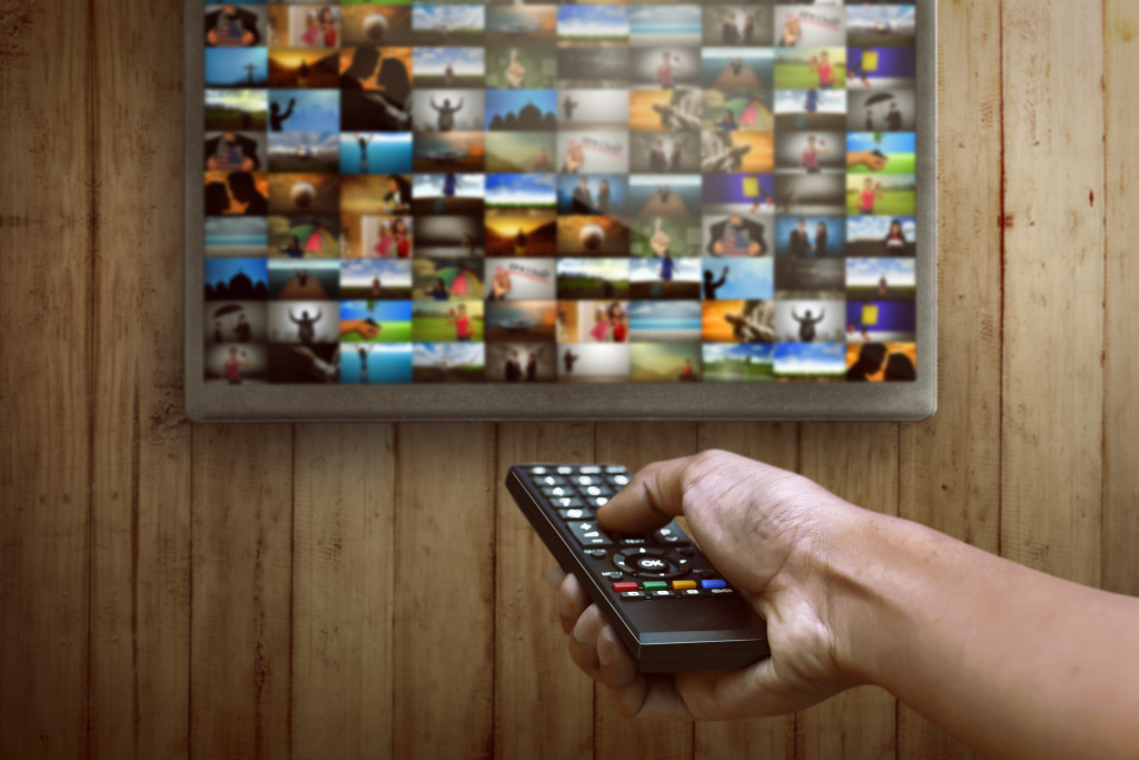 Man choosing channel on the smart tv what to watching
